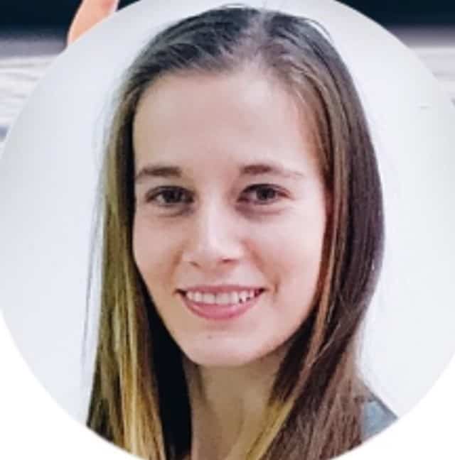 A smiling woman with long brown hair presented in a circular frame.