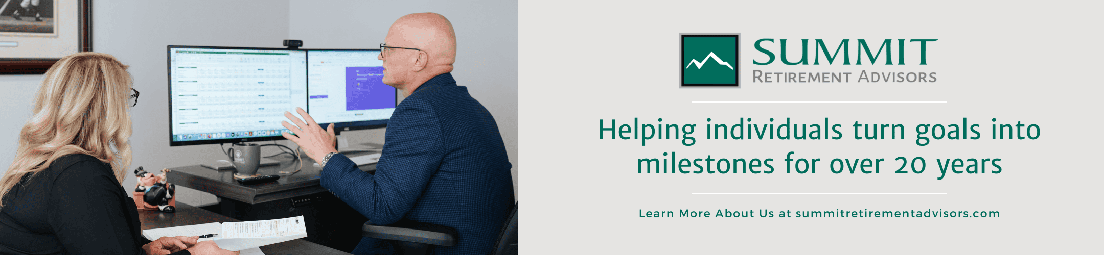 Two professionals in an office setting, with one showing something on a computer monitor. Text on the right reads, 