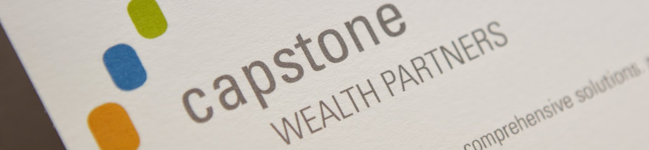 Close-up of a printed business card showing the logo and name 